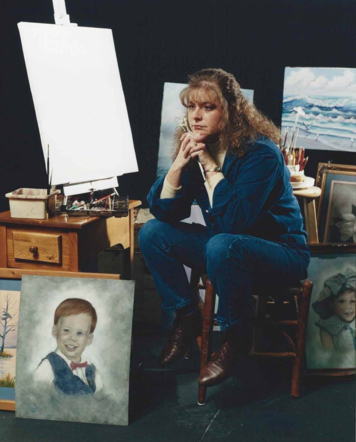Deliah Smith in her art studio with her artwork